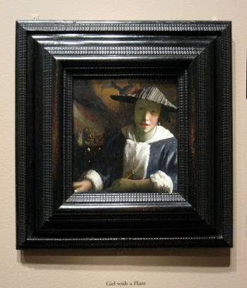 Girl with a Flute by Johannes Vermeer in its frame