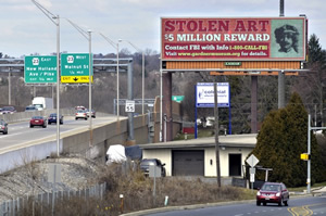 Poster on highway announcing reward for recovery of stolen Vermeer painting